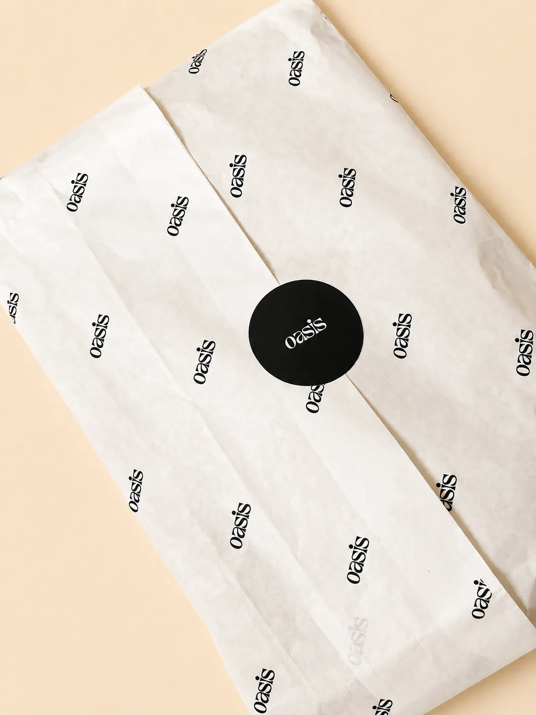 Branded tissue paper and sticker seal for a fashion brand